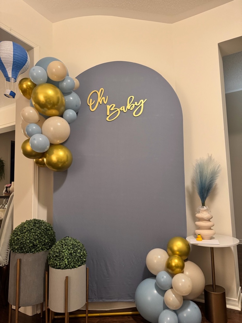 Arched frame with blue fabric and Oh Baby sign